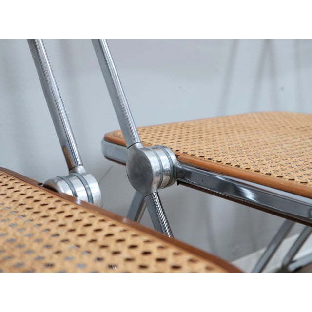 This exceptional set of four plia chairs, designed by giancarlo piretti for castelli, represents a rare and coveted...