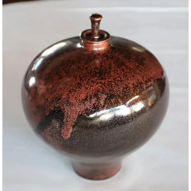 Large "Toupie" box with small precious caps of Xavier Duroselle 1990. Porcelain with black powder enamel with copper...