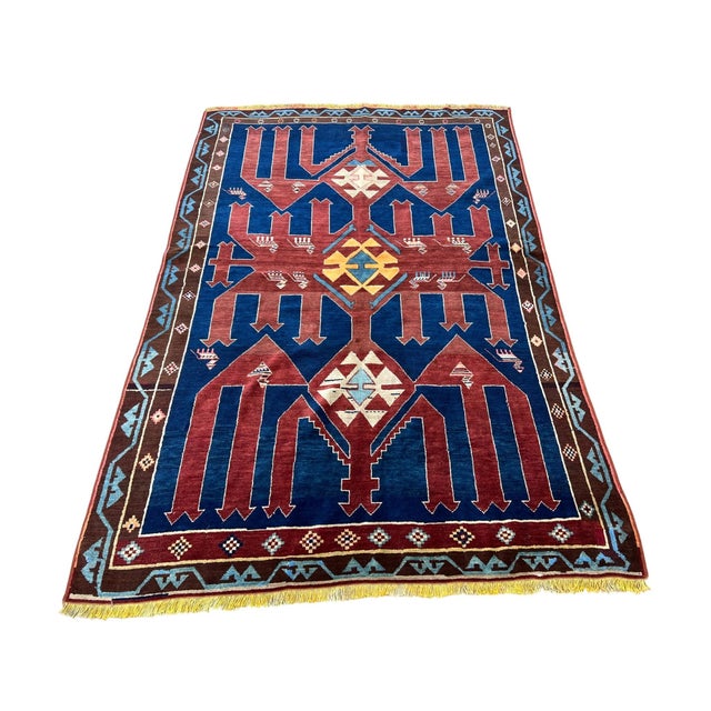 Vintage Turkish rug, hand knotted in Turkey from 100% wool. Measuring 4’8” x 7’2”, this bold tribal rug features a...
