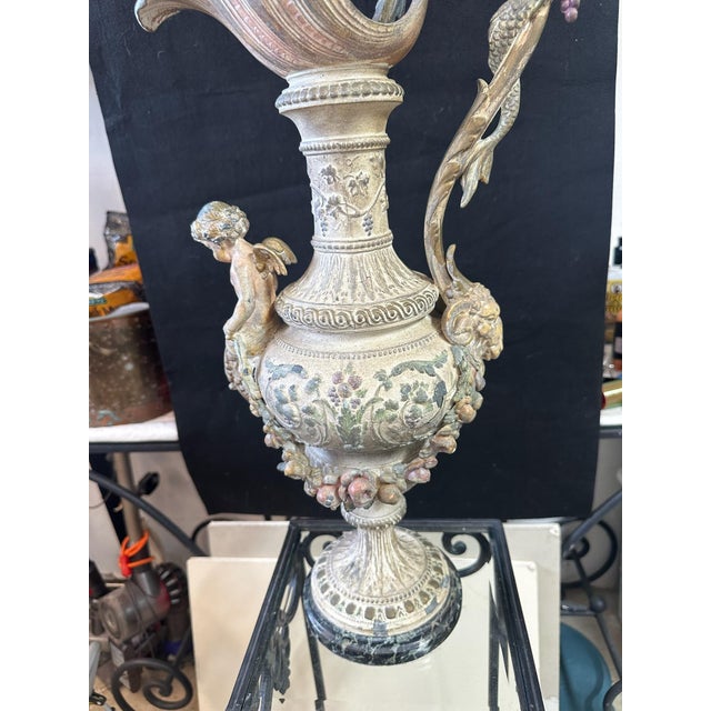 Large and highly decorative vintage figural ewer featuring an elaborate Renaissance Revival–inspired composition with a...