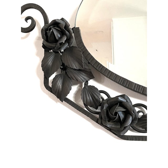 Antique Art Deco wrought iron hammered frame, surrounded by wonderful iron roses, leaves, scrolls, and a beveled mirror.
