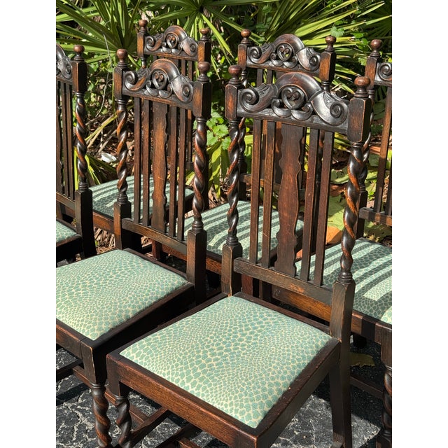 Striking set of six antique dining chairs featuring beautifully carved crest rails, intricate barley-twist supports,...