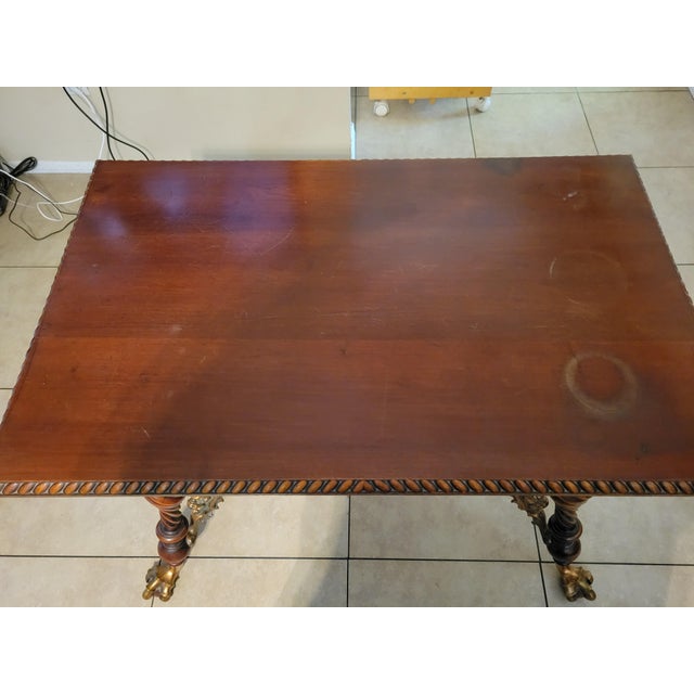 Merklen Brothers of New York, 1880s mahogany parlor table, featuring brass Griffins and classic clawed feet grasping...