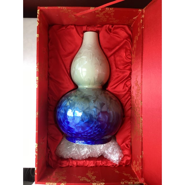 A luminous study in contrast and craftsmanship, this vintage Chinese porcelain vase features a striking crystalline glaze...