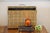 This vintage piece from the 1970s is a plaid-patterned brass-wrapped wooden magazine stand. Made to sit on the floor next...