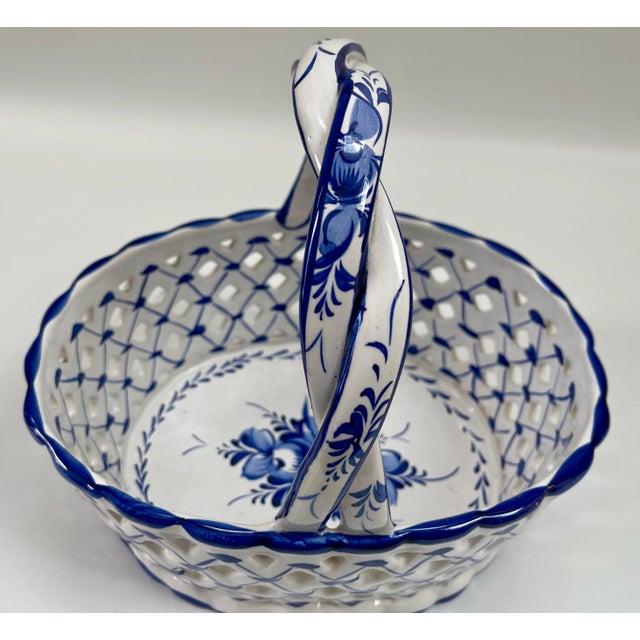 Beautifully decorated pierced hand-made and hand-painted blue and white centerpiece basket with large center blue floral...