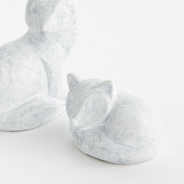 This sweet little duo of lazing fox sculptures is made of concrete and finished in aWhitewash. A charming accent for the...