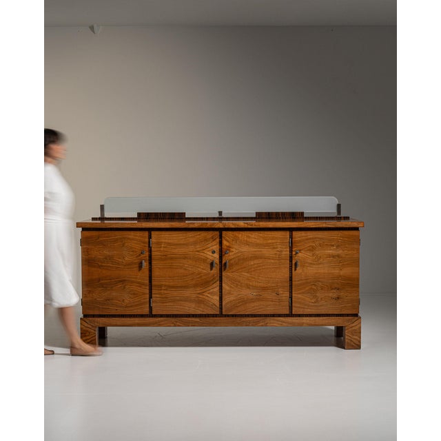 Glass-top walnut sideboard in Rich Walnut Brown. Its rich walnut brown finish sets off four doors, protective glass top...