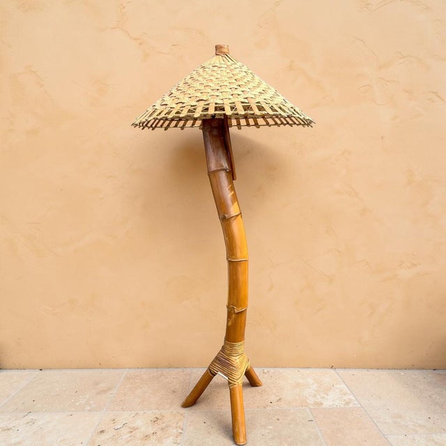 Vintage 1970s monumental coastal bamboo floor lamp. This is a unique, solid piece of curved bamboo, weaved with wicker to...