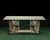 A striking late 19th-century English bankers table or desk featuring a bold double-eagle base crafted from galvanized zinc...