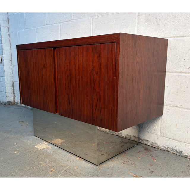 A refined vintage Danish buffet crafted from richly grained rosewood and elevated on a sleek chrome base. This elegant...
