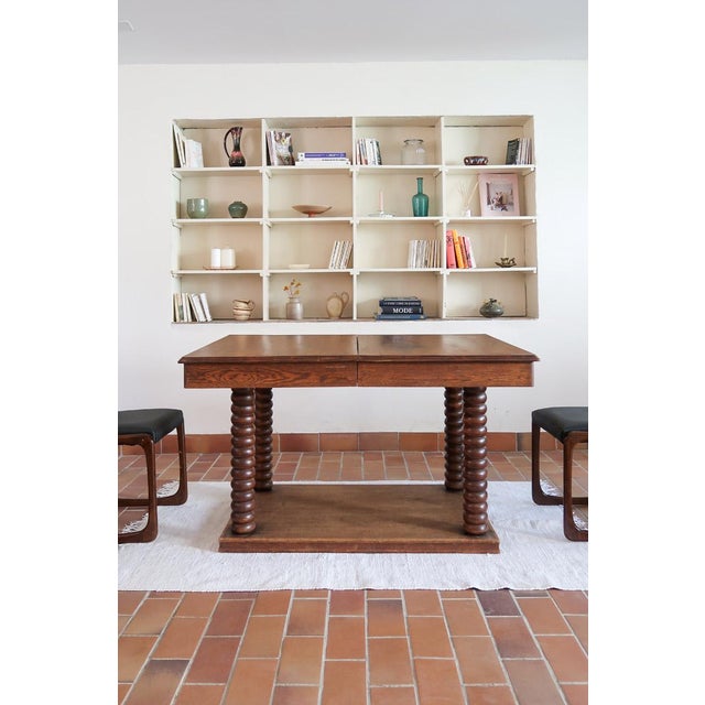A French dining table in solid oak, rustic Art Deco, 1930s-40s. What makes this table is the base: four bobbin-turned legs...