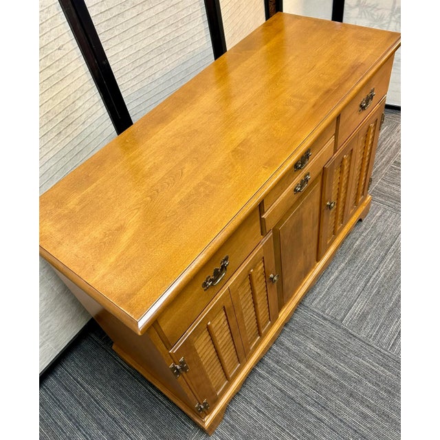 Solid maple buffet/server cabinet. Louvre doors, two drawers with felt lining and a shelved storage space below. Sturdy,...