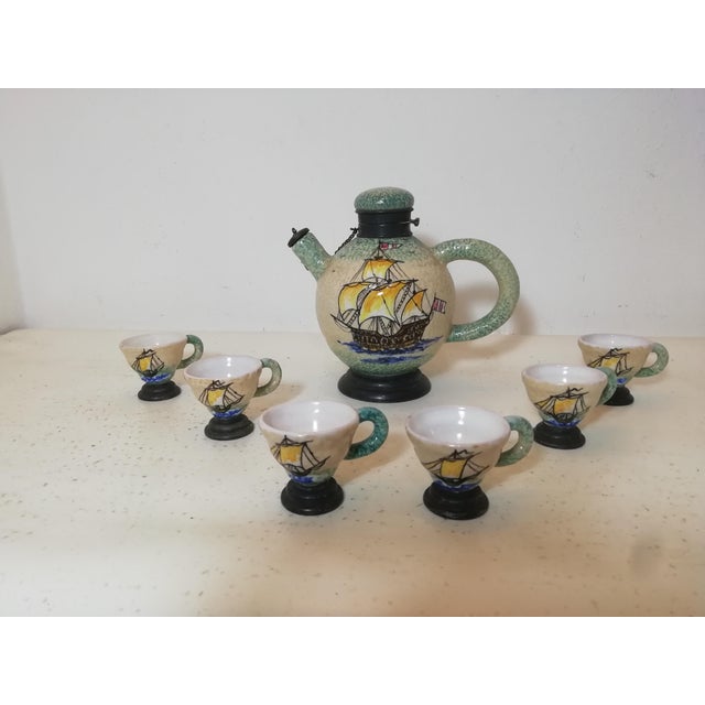 Ceramic rosolio set with metal base. Made by La Casa dell'Arte of Albisola. Futurist period piece. Sailing ship...