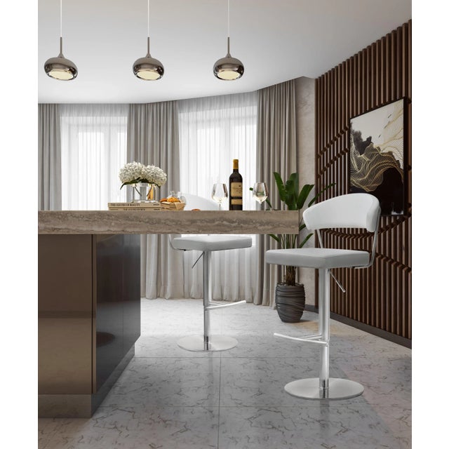 Furnish your kitchen or bar area in contemporary style with the Cosmo stool from TOV. The solid stainless steel frame...