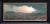 In "Phone Home," a vast, desolate landscape unfolds under a dramatic sky, where muted colors evoke a sense of solitude and...