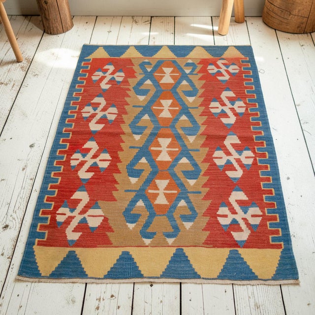 A village kilim woven for personal domestic use by Oushak artisans in the Aegean region of Anatolia, this 1990s flat weave...