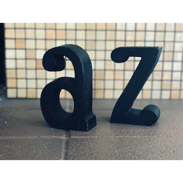 A pair of solid Iron book ends in the shape of the letters A and Z with original green felt bottoms. Solid! Weigh 6 lbs...