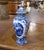Featuring traditional Dutch countryside scenes and intricate floral decoration, this vintage Delft-style covered vase was...