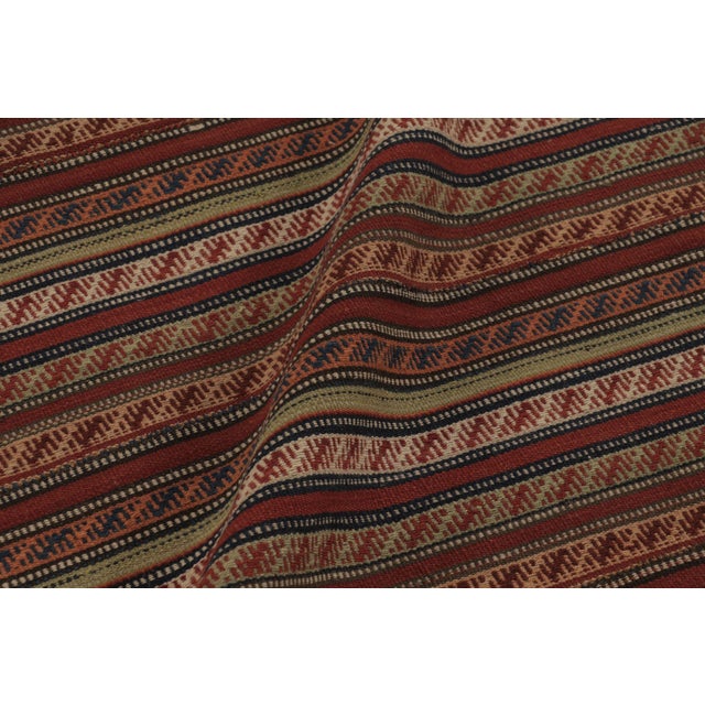 Handwoven in wool and originating circa 1950-1960, this 5x6 vintage Persian kilim is a masterfully curated tribal addition...