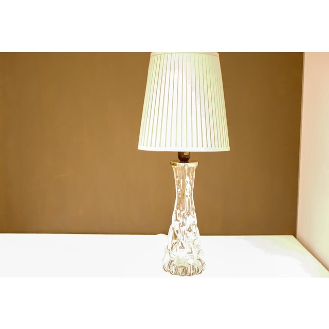 A crystal glass table lamp, model RD 1477, designed by Carl Fagerlund for the prestigious Swedish glassmaker Orrefors,...