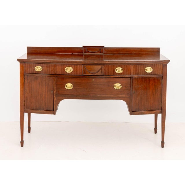 American Federal Style Mahogany Sideboard, with swag and ribbed motif, one long frieze drawer above central drawer and two...