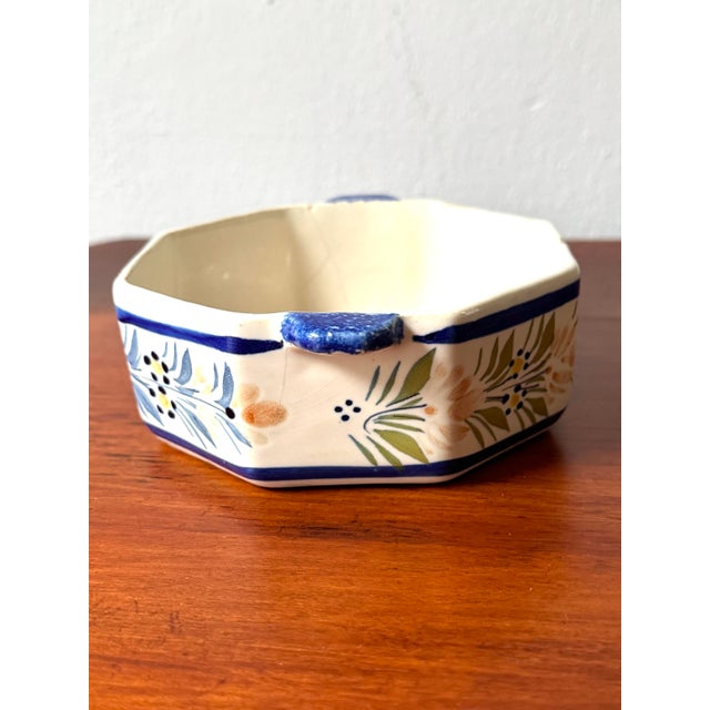 Evoking the rustic charm of the Brittany coastline, this authentic French faience double-handled dish is a beautiful...