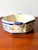 Evoking the rustic charm of the Brittany coastline, this authentic French faience double-handled dish is a beautiful...