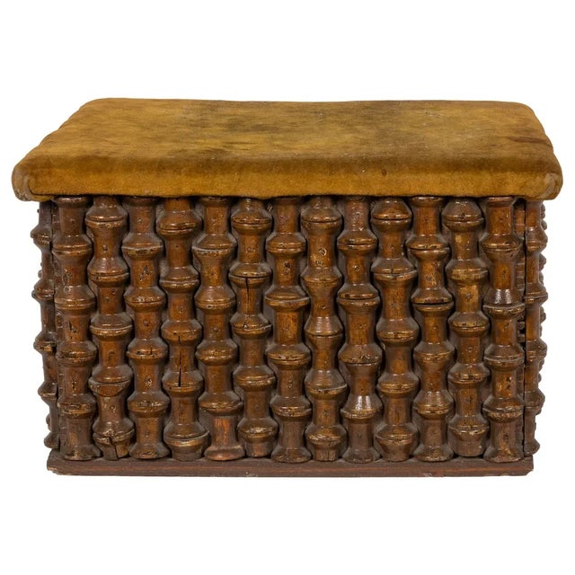 Charming and unusual American folk art petit footstool. Constructed of spools and topped with a golden velvet platform.