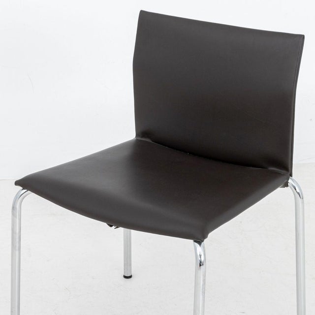 Postmodern Chocolate Brown Leather Side Chair, on four tubular chrome legs. 30.25" H x 21" W x 20.5" D; seat: 17.5" H....