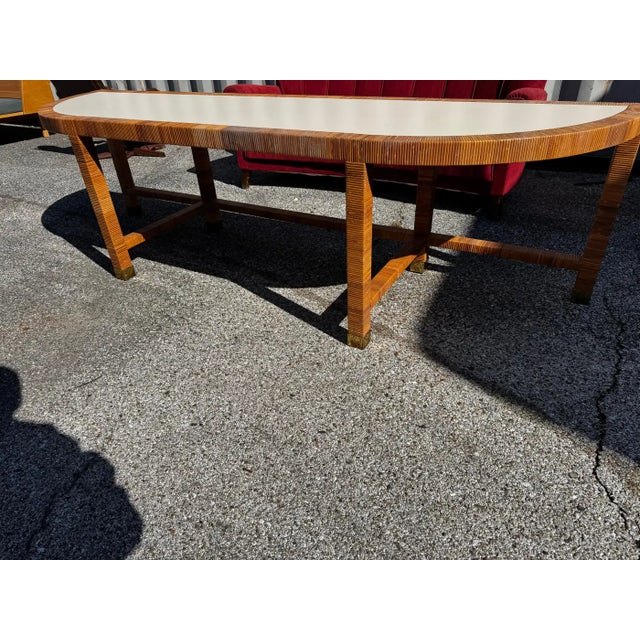 This console is 96" x 26"d x 26"h. It is wrapped in rattan and has brass caps on the feet. It dates to the late 70's -...