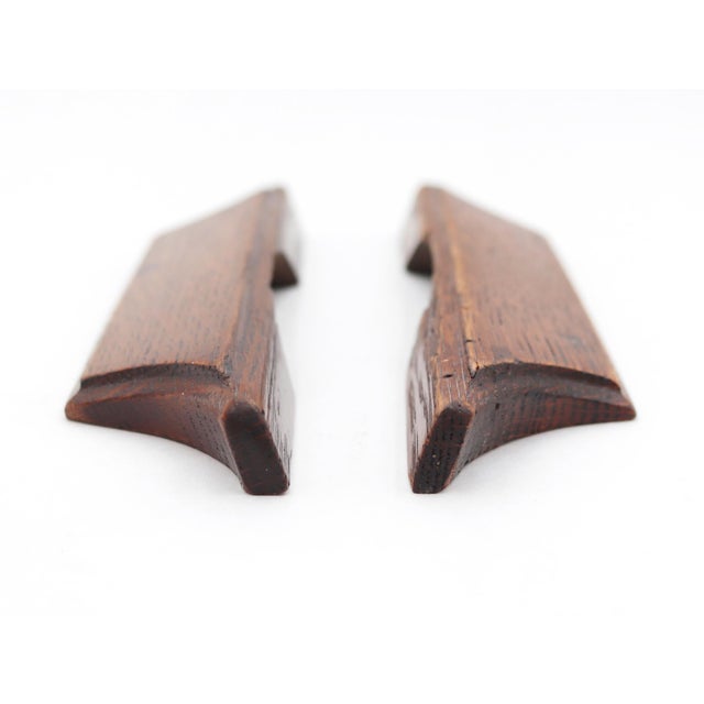 Vintage oak drawer pulls featuring a recessed contour, allowing fingers to grip and pull the drawer open smoothly. The...