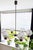 This six-arm chandelier combines textured pressed glass shades with warm wood-veneered fittings and a restrained metal...