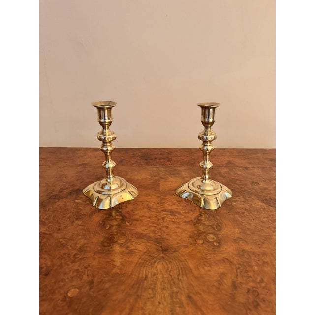 Quality pair of antique Queen Ann brass candlesticks having a quality original pair of antique Queen Ann petal base brass...