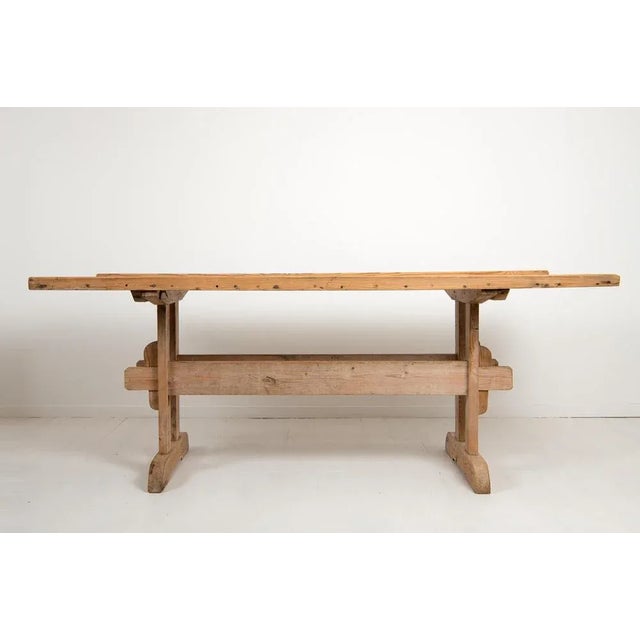 Northern Swedish country dining table. The table is a so called trestle table from the mid 19th century and made in pine...