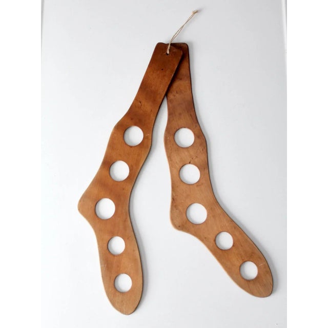 This is a pair of antique stocking stretchers, also known as stocking airers. The wooden stretchers feature five round...