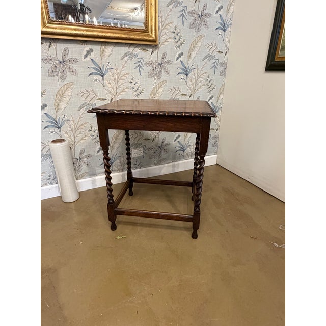 Such a lovely piece of history, this side table features distinctive legs and a delicate scalloped top. This would be a...
