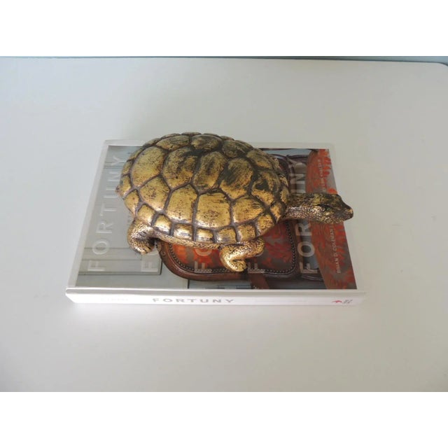 Gold Leaf Terracotta Turtle Candle from Mexico. Gold leaf over terracotta with (3) candle wicks inside. Size: 12"L x 7"W x...