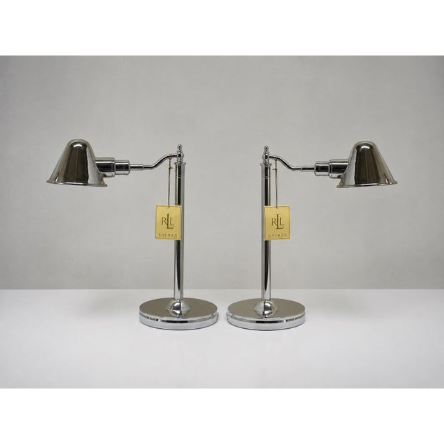 A sophisticated pair of Ralph Lauren polished nickel desk lamps, combining timeless library-inspired design with the...