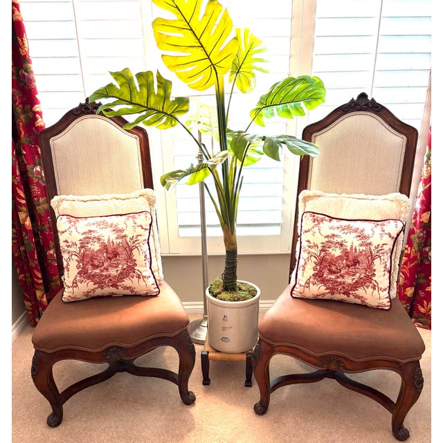 An exceptional pair of Henredon French Provincial accent chairs that beautifully showcase the craftsmanship, elegance, and...