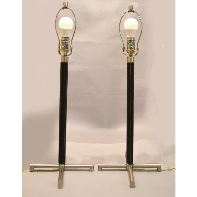 Pair of Nessen Lighting Table Lamps in stainless steel with black Leather Accent. The sleek, modern lines of the Nessen...