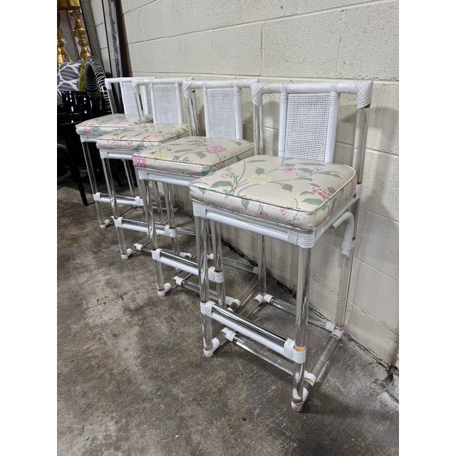 Hard to find vintage lucite barstools with white wicker wrapping and vinyl floral cushions. Typical vintage condition with...
