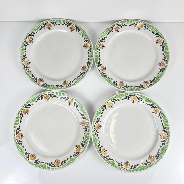 Set of 4 Sarreguemines "Maroussia" dinner plates, early 20th century White, green, orange and black Dimensions: Diameter:...