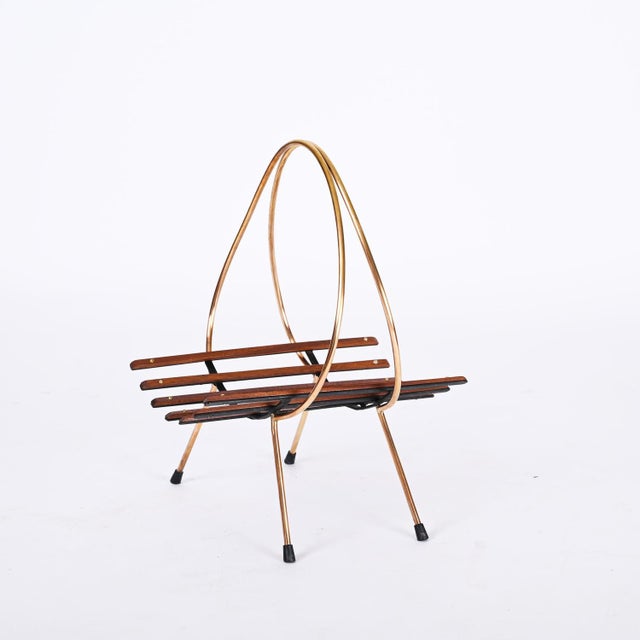 Beautiful and unique mid-century magazine rack in metal, teak and brass. This fantastic piece was produced in Italy during...
