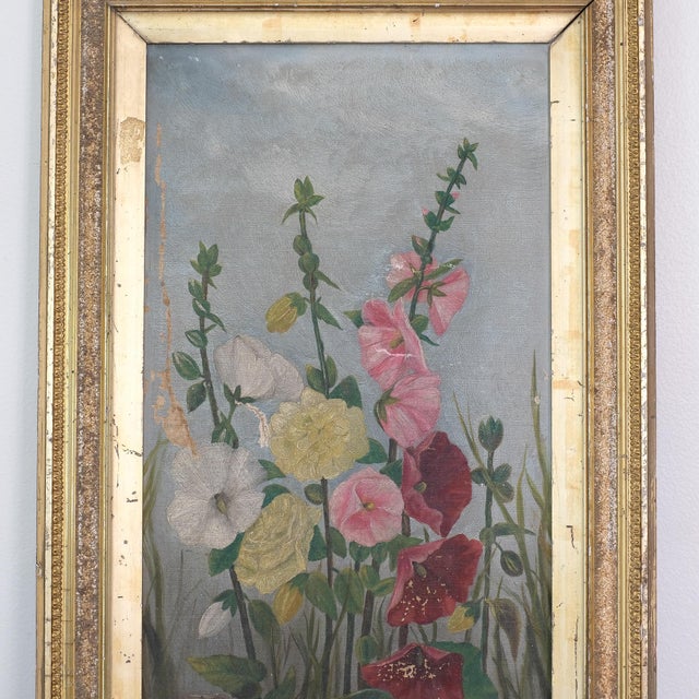 Stunning antique floral hollyhocks oil painting, set in an ornate gilt frame. *Please note there are signs of wear on the...