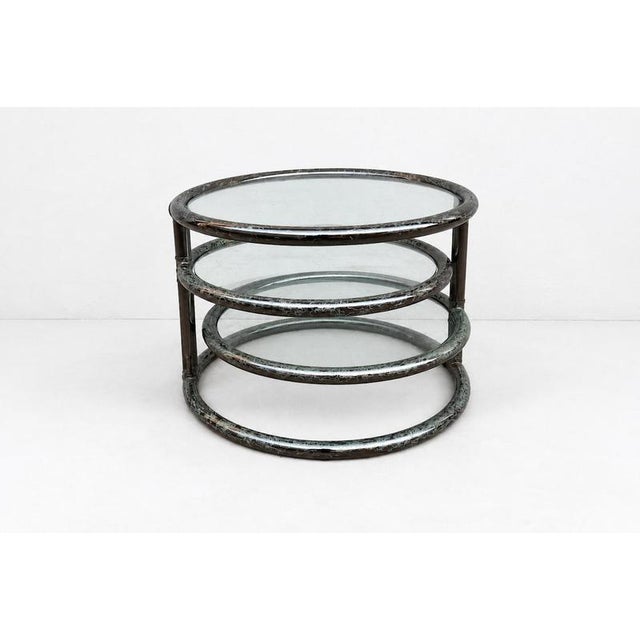 1980’s vintage three-tier coffee table produced in Italy. This is a stunning swivel tubular steel frame and glass coffee...