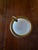 This is a vintage French opaline glass ashtray, featuring a milky white opaque body set within an ornate gilt brass or...