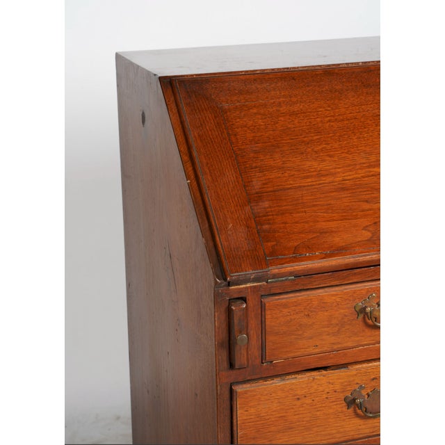 A beautifully aged and wonderfully useful antique Georgian-style slant front secretary desk, richly patinated in warm oak...