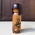 Small vintage kokeshi by the renowned master Okamoto Usaburo, with an understated cylindrical form and a warm natural wood...