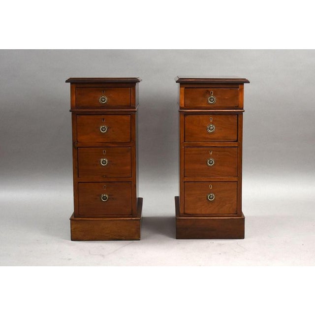 A charming pair of Victorian mahogany bedside chests, each fitted with four graduated drawers retaining attractive brass...